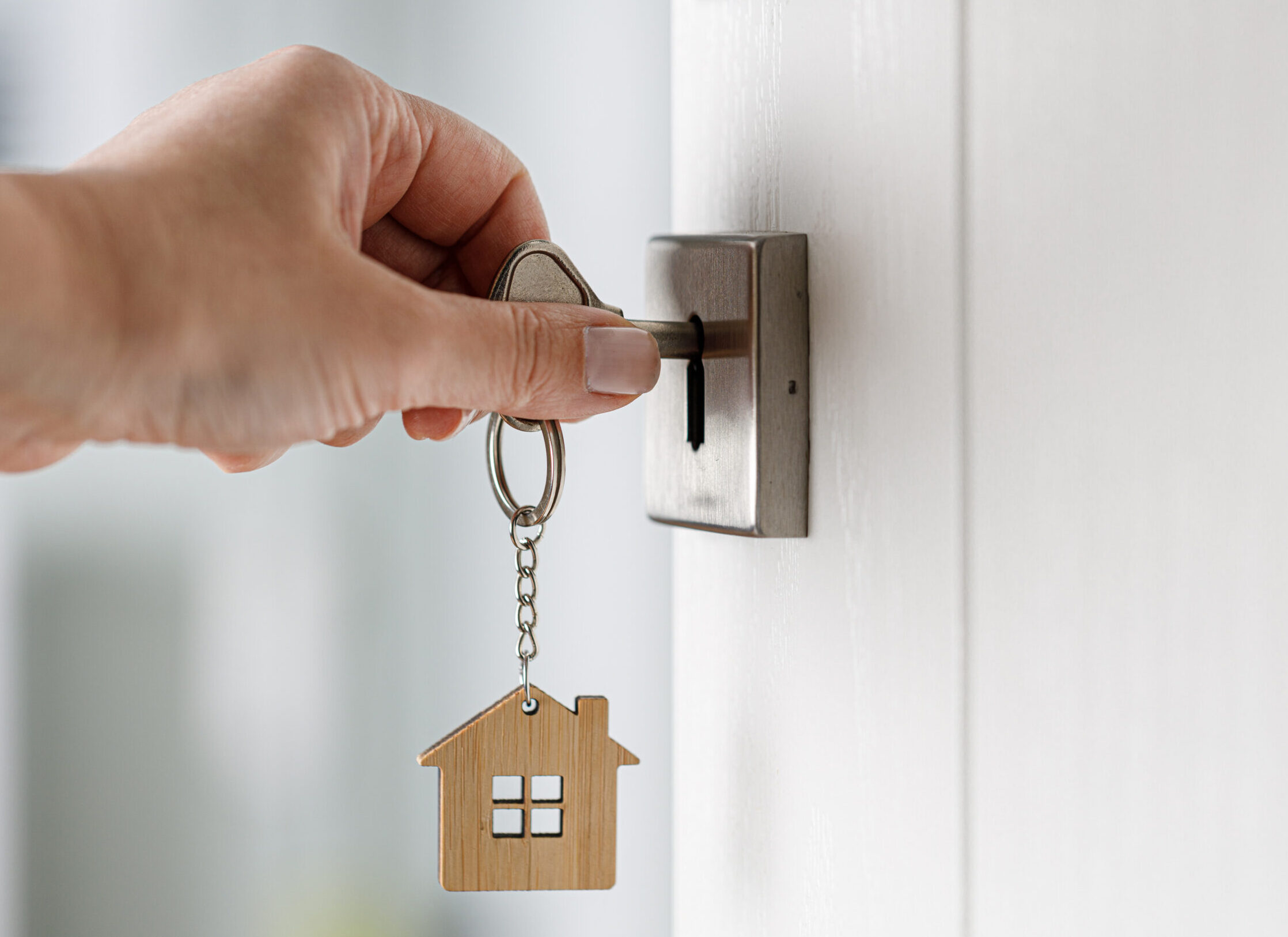Woman hand opening a door with key