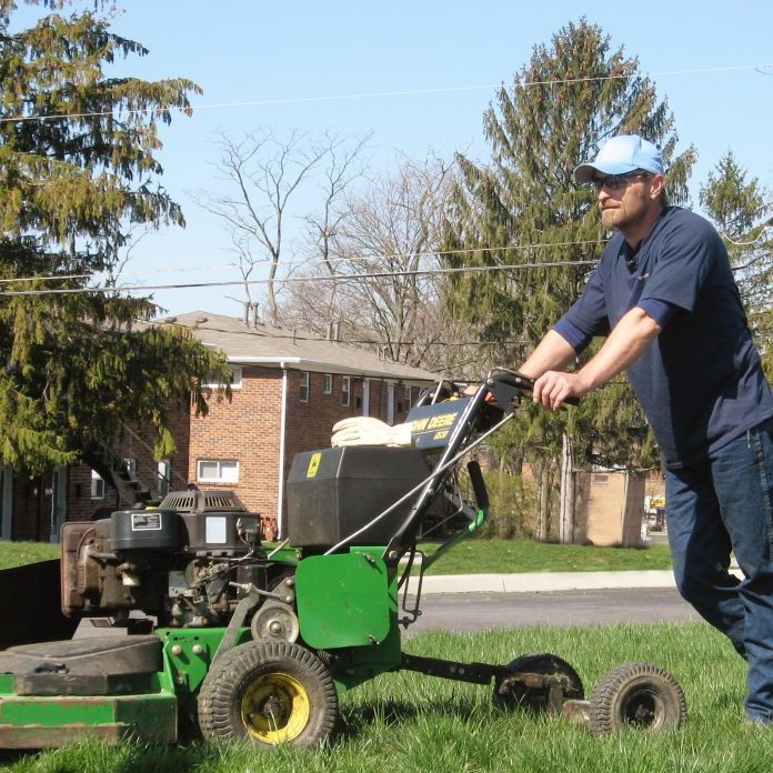 man with mower
