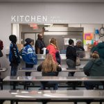 women in line for food in community kitchen
