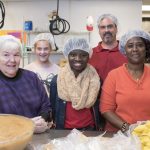 volunteer group with hairnets on