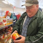 man holding can of soup