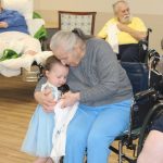 resident with grandchild hugging