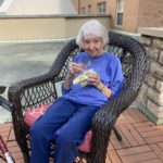 assisted living woman sitting outside