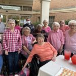 group of assisted living residents at a breast cancer awareness event