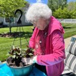 assisted living woman planting flowers